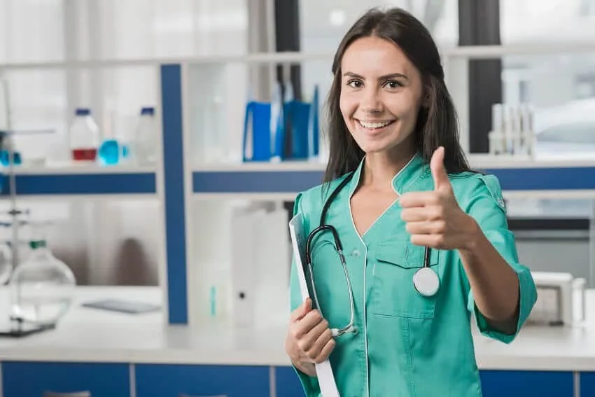 Doctora o enfermera del sector salud de IMSS Bienestar haciendo señal de aprobación para solicitar crédito vía nómina